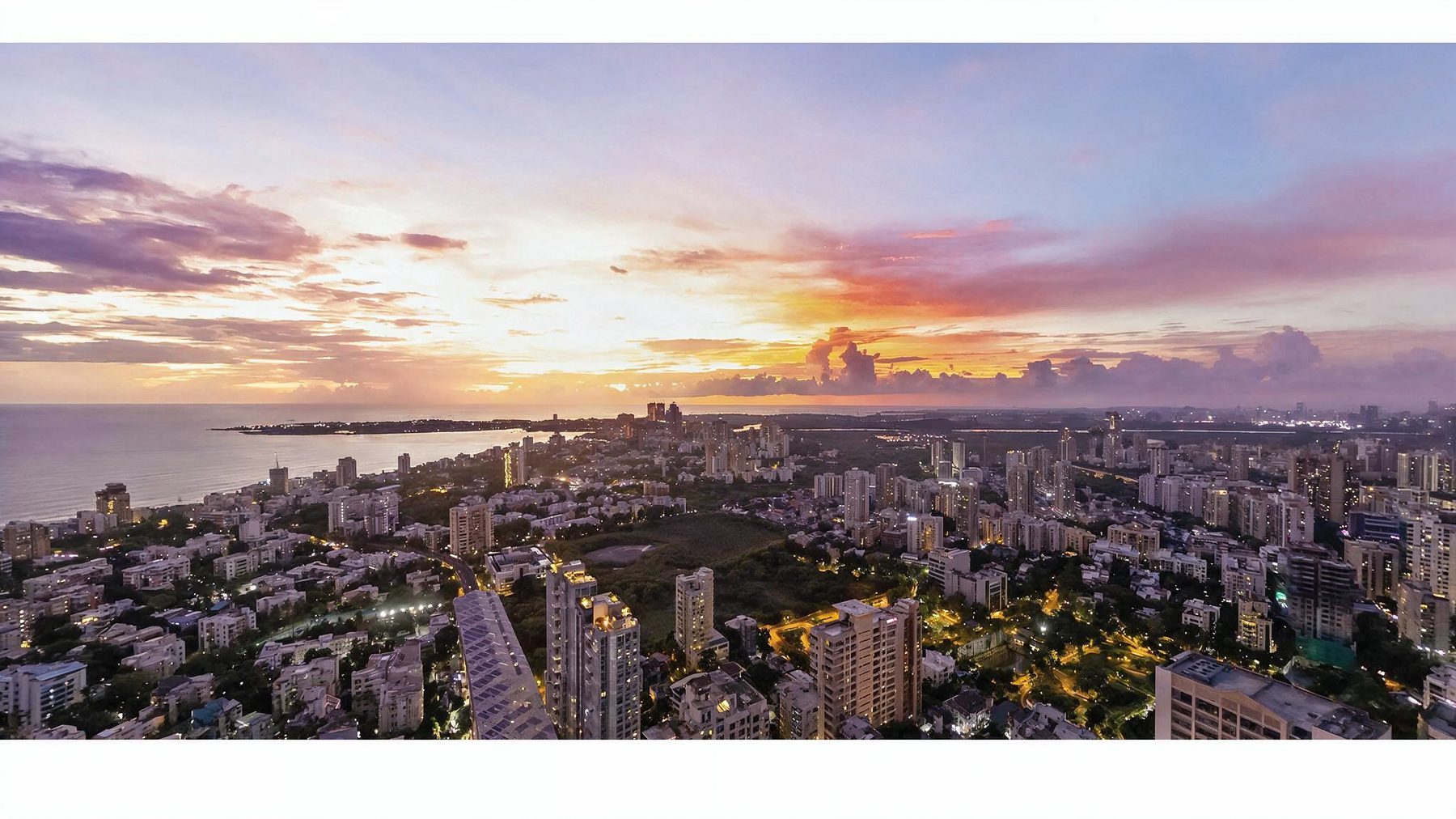 Aerial view over Andheri West towards the sea at sunset